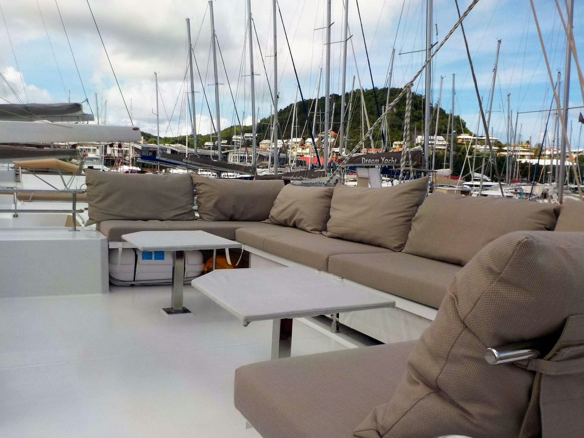 a living room with a large window overlooking a marina aboard DREAM TOBAGO Yacht for Charter