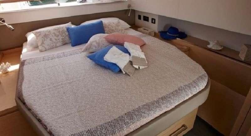 a bed with pillows aboard DREAM TOBAGO Yacht for Charter