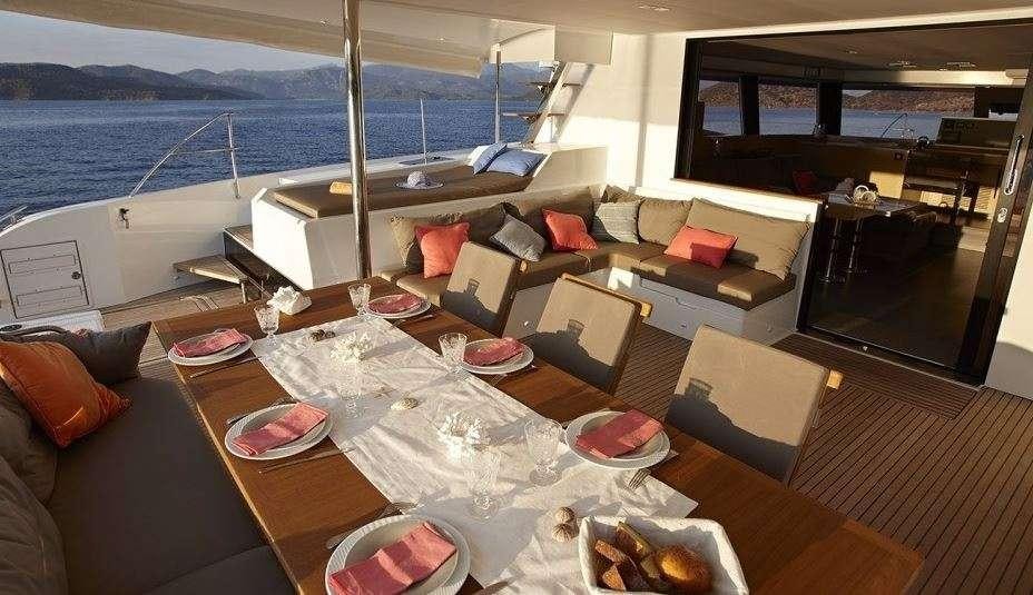 a living room with a large balcony aboard DREAM TOBAGO Yacht for Charter