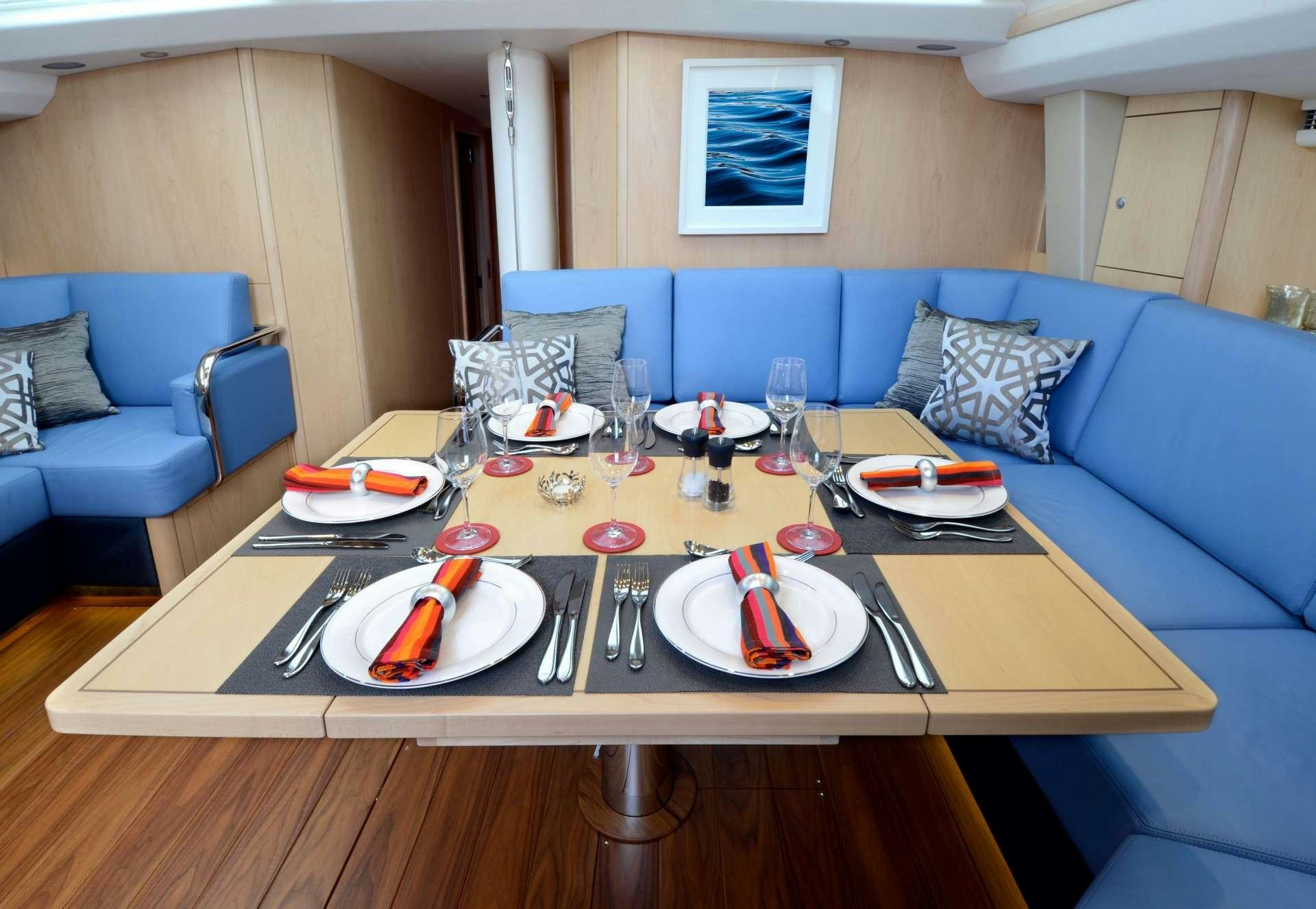 a table with plates and cups on it aboard LATITUDE Yacht for Charter
