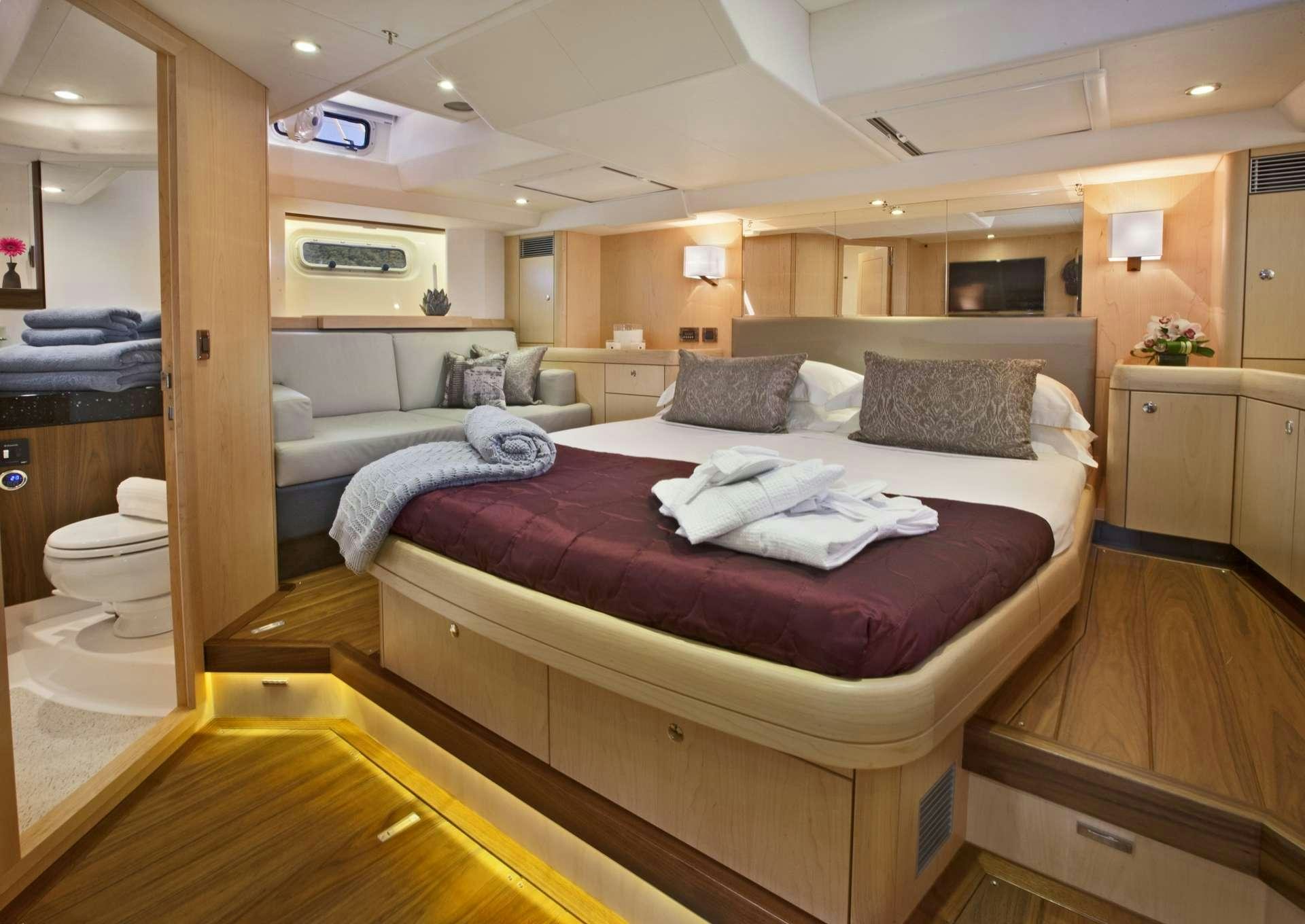 a bedroom with a bed and a mirror aboard LATITUDE Yacht for Charter