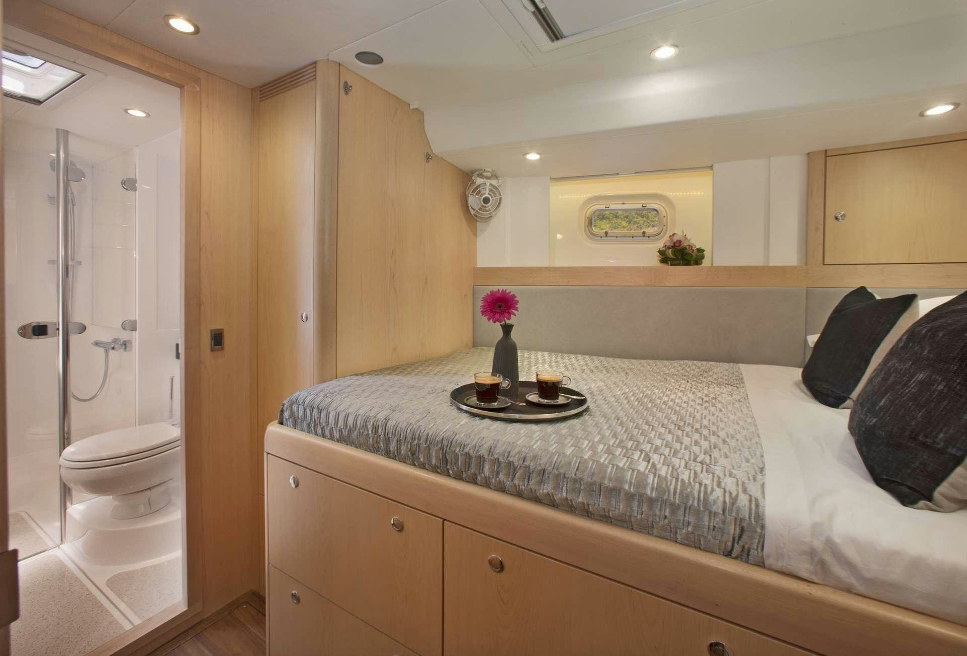 a bed with a tray on it aboard LATITUDE Yacht for Charter