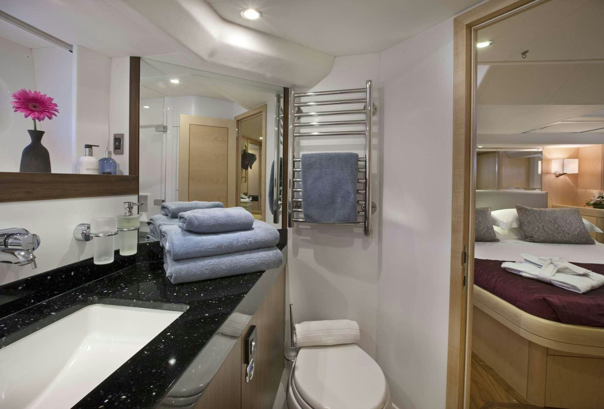 a bathroom with a large mirror aboard LATITUDE Yacht for Charter
