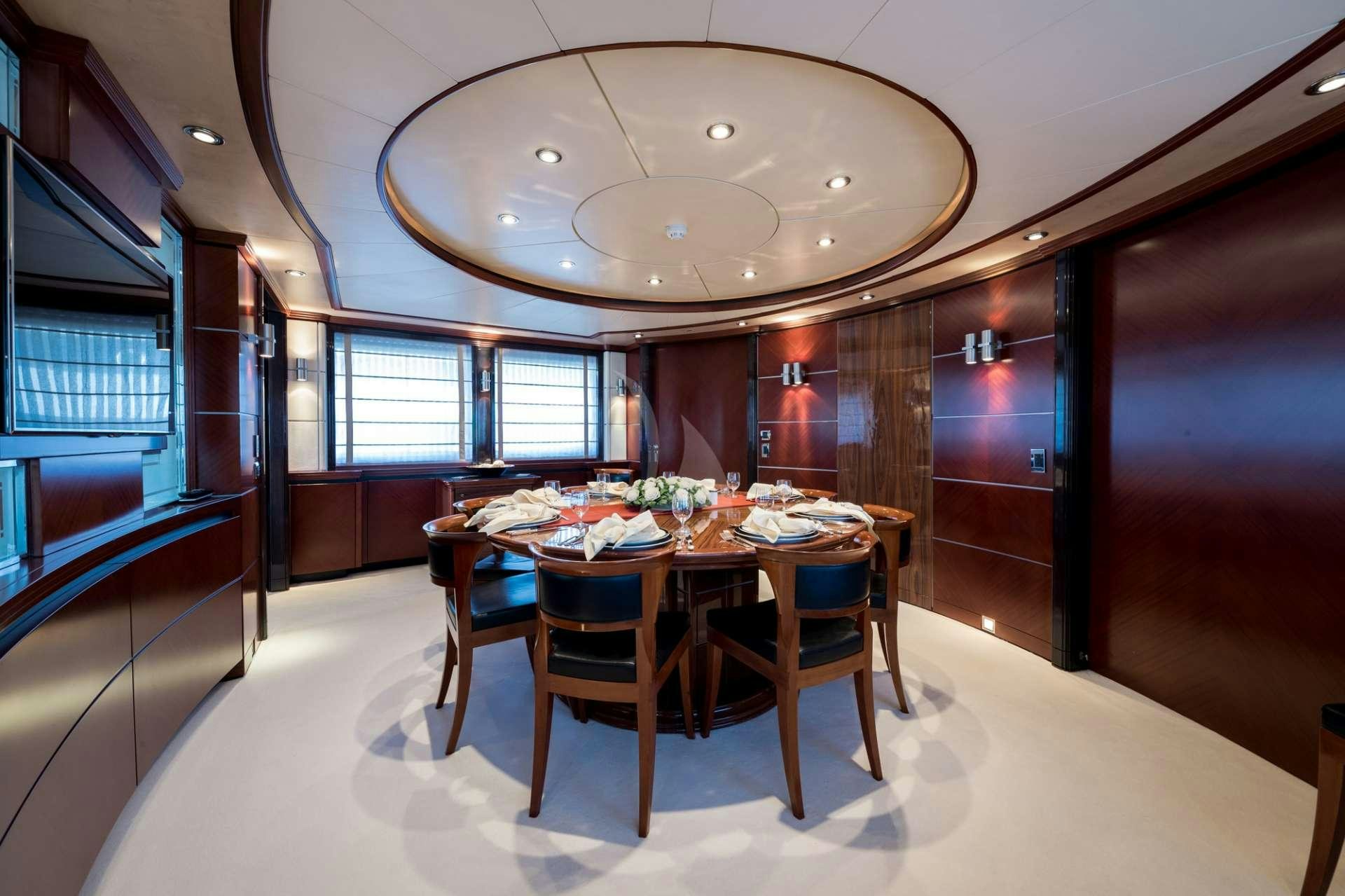 a dining room with a table aboard MAGENTA M Yacht for Charter
