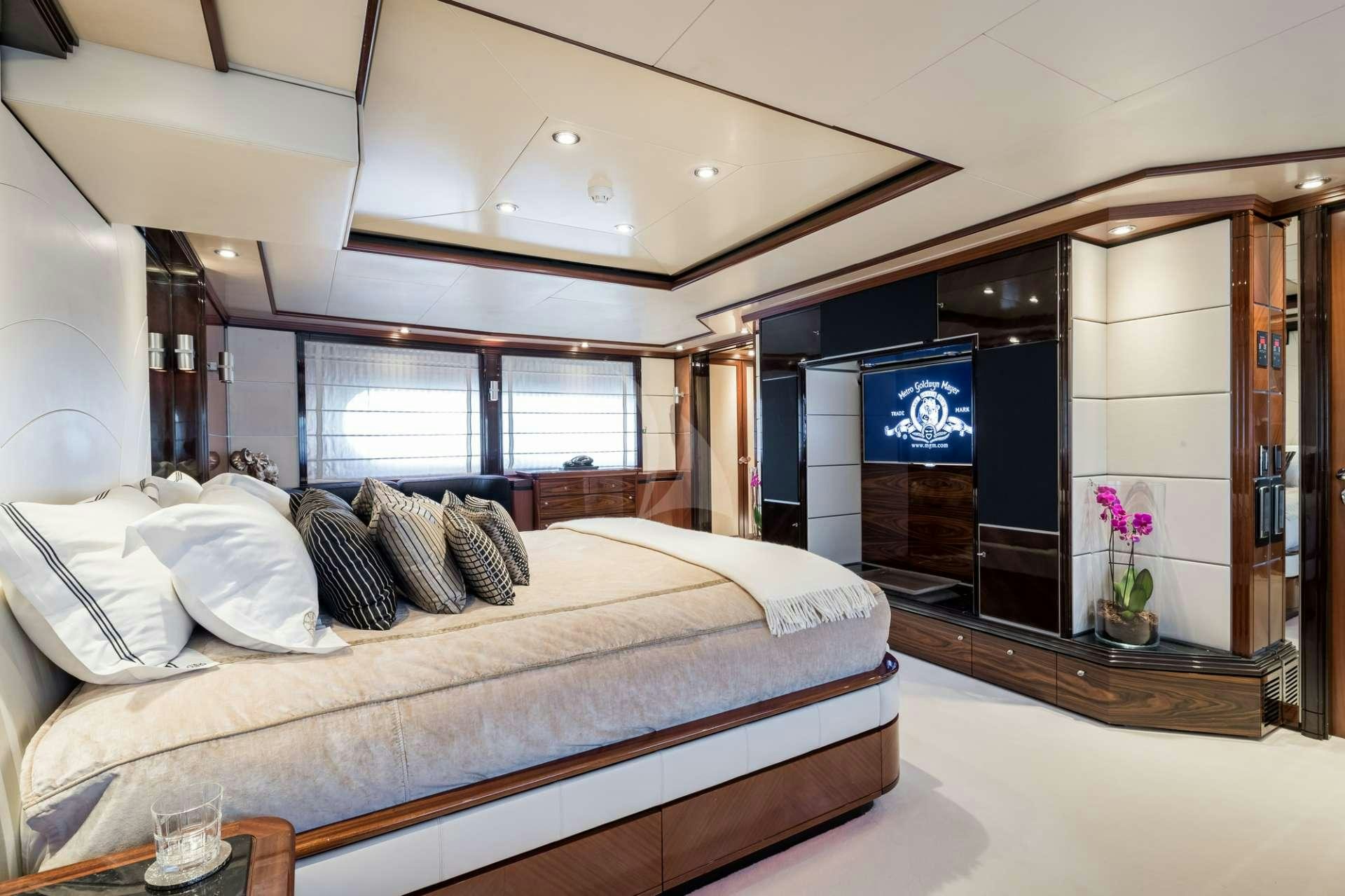 a bedroom with a bed and a fireplace aboard MAGENTA M Yacht for Charter
