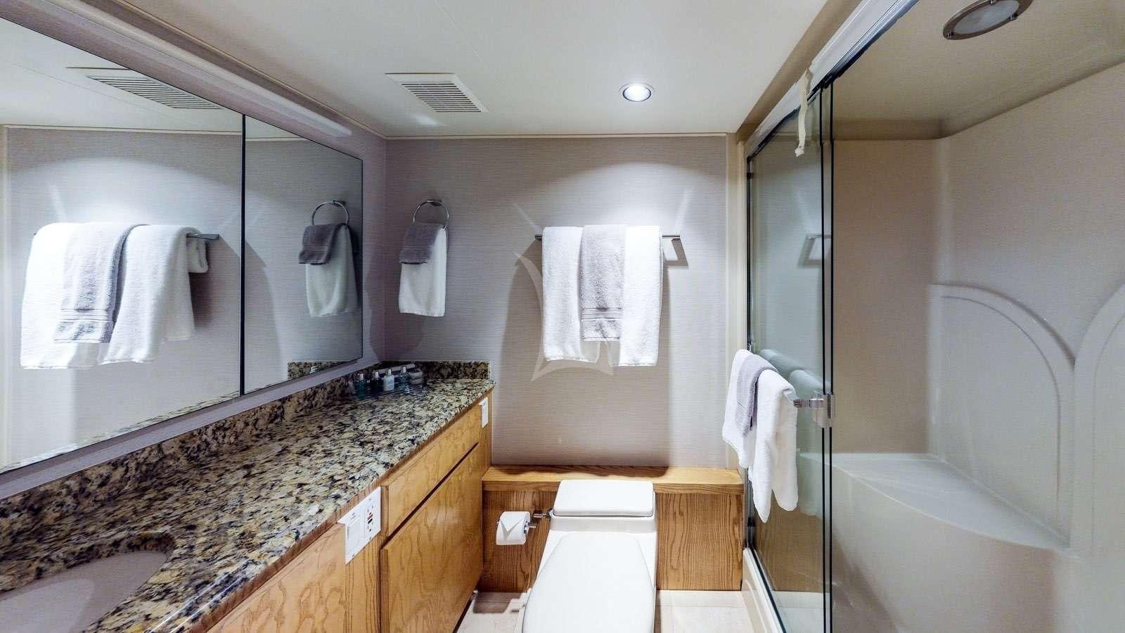 a bathroom with a marble countertop aboard XOXO Yacht for Charter