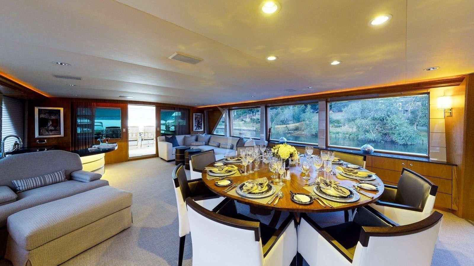a large dining room with a large table and chairs aboard XOXO Yacht for Charter
