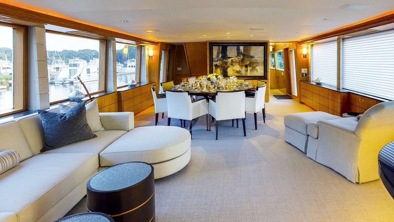 a living room with a table and couches aboard XOXO Yacht for Charter