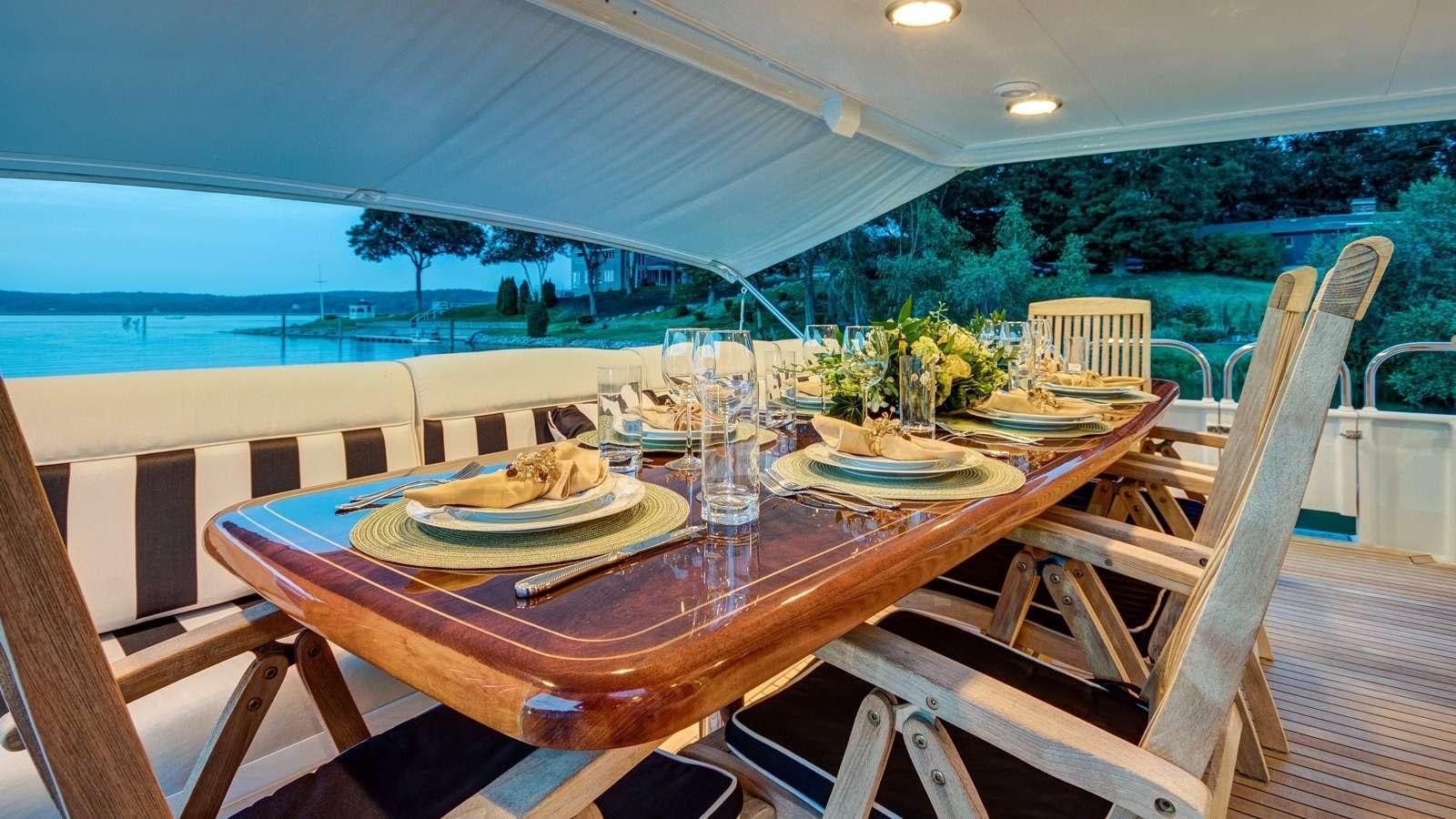 a table with plates and glasses on it aboard XOXO Yacht for Charter