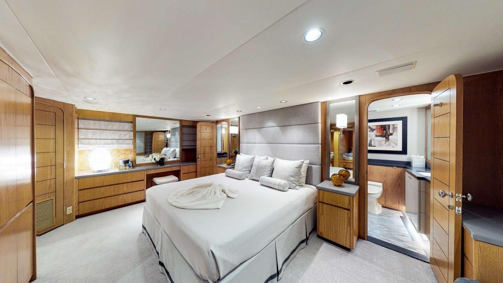 a large bedroom with a large bed aboard XOXO Yacht for Charter