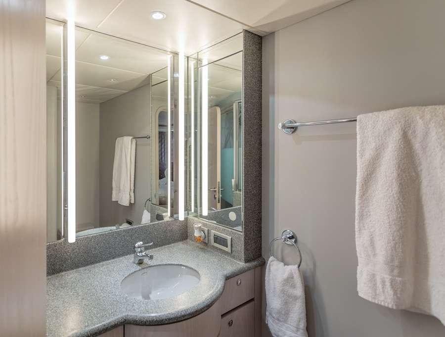 a bathroom with a sink and a mirror aboard PRIME TIME Yacht for Charter