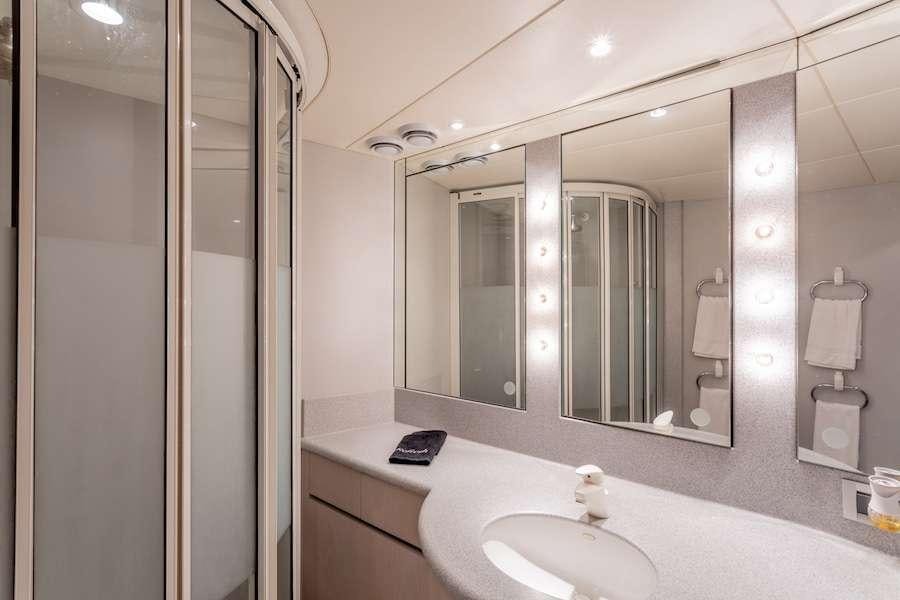 a bathroom with a large mirror aboard PRIME TIME Yacht for Charter