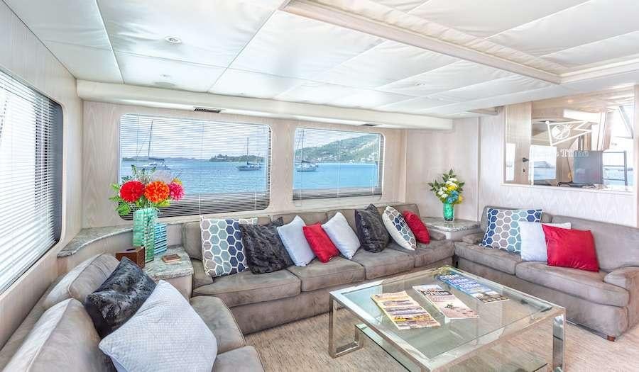 a living room with a couch and a coffee table aboard PRIME TIME Yacht for Charter