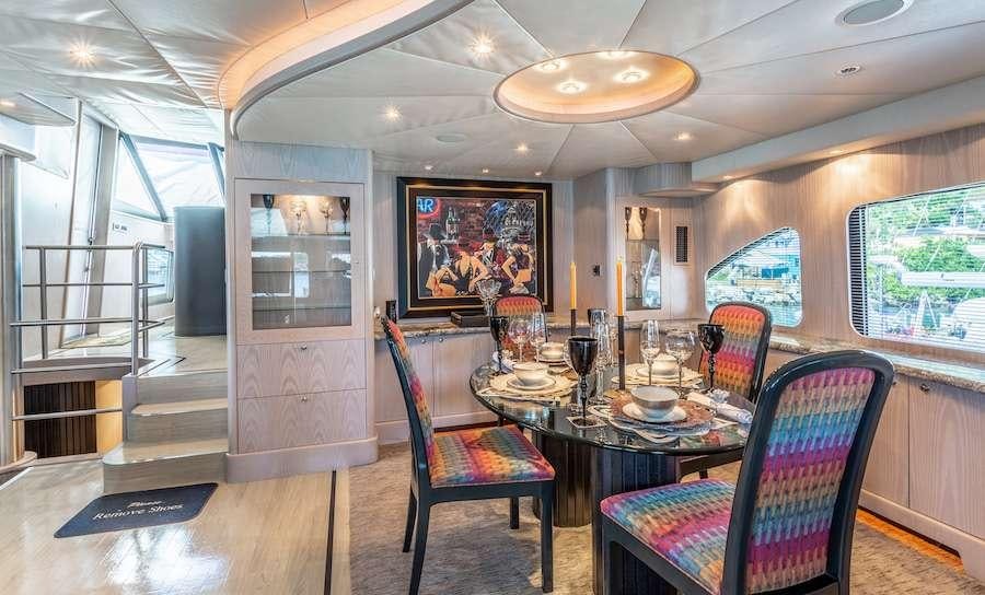 a dining room with a table and chairs aboard PRIME TIME Yacht for Charter