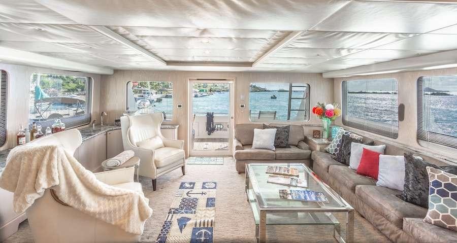 a living room with a couch and a table aboard PRIME TIME Yacht for Charter