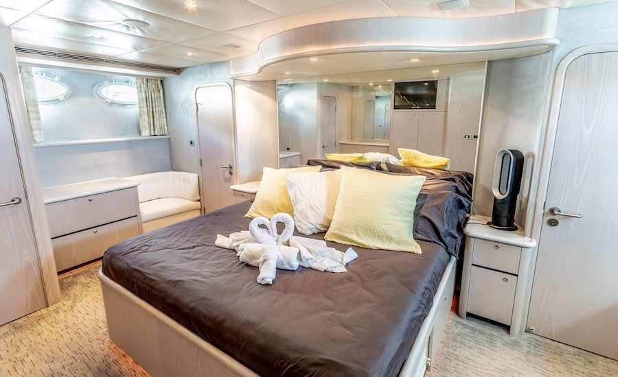a small bedroom with a bed aboard PRIME TIME Yacht for Charter