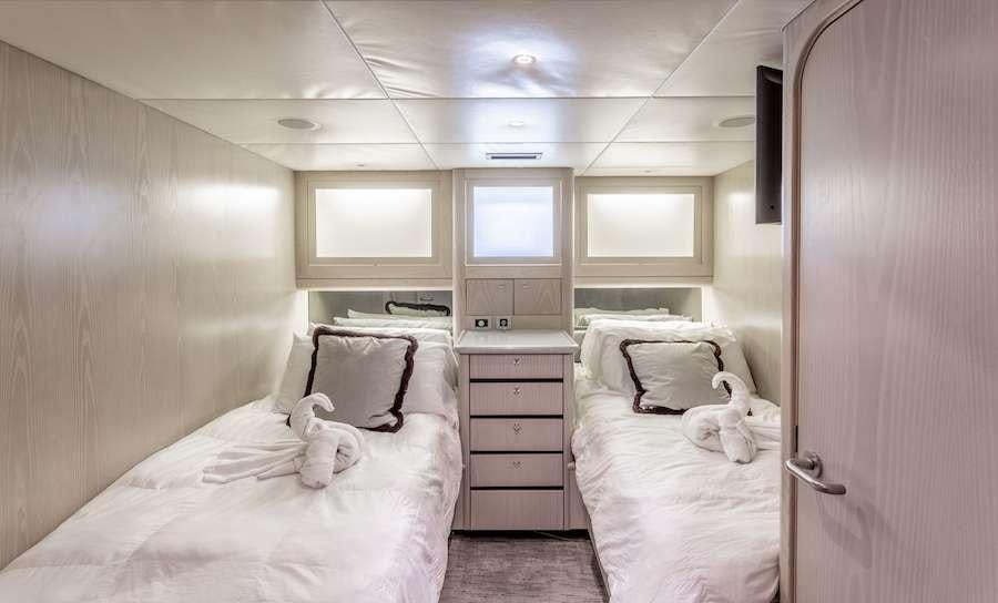a room with two beds aboard PRIME TIME Yacht for Charter