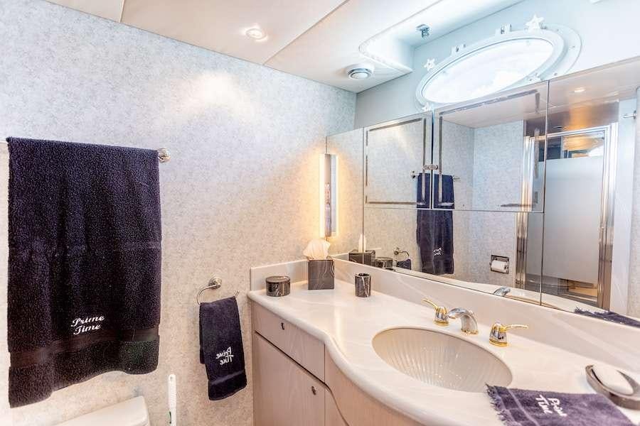 a bathroom with a large mirror aboard PRIME TIME Yacht for Charter