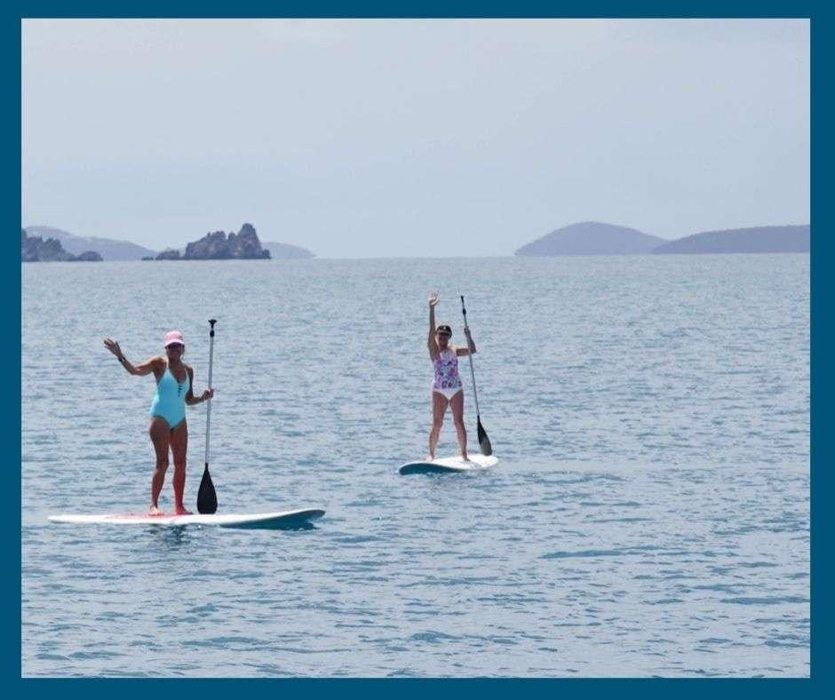 two women on surfboards aboard VIRAMAR Yacht for Charter