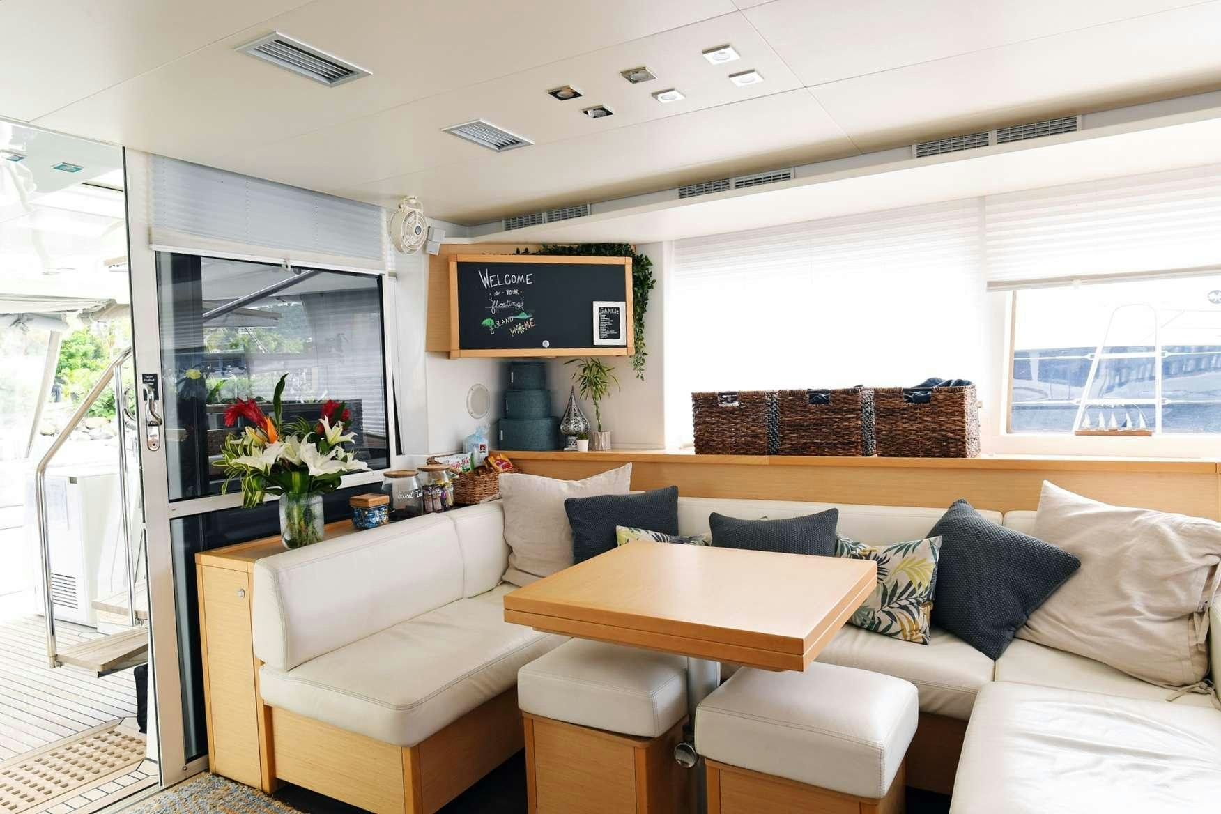 a living room with a couch and a tv aboard VIRAMAR Yacht for Charter