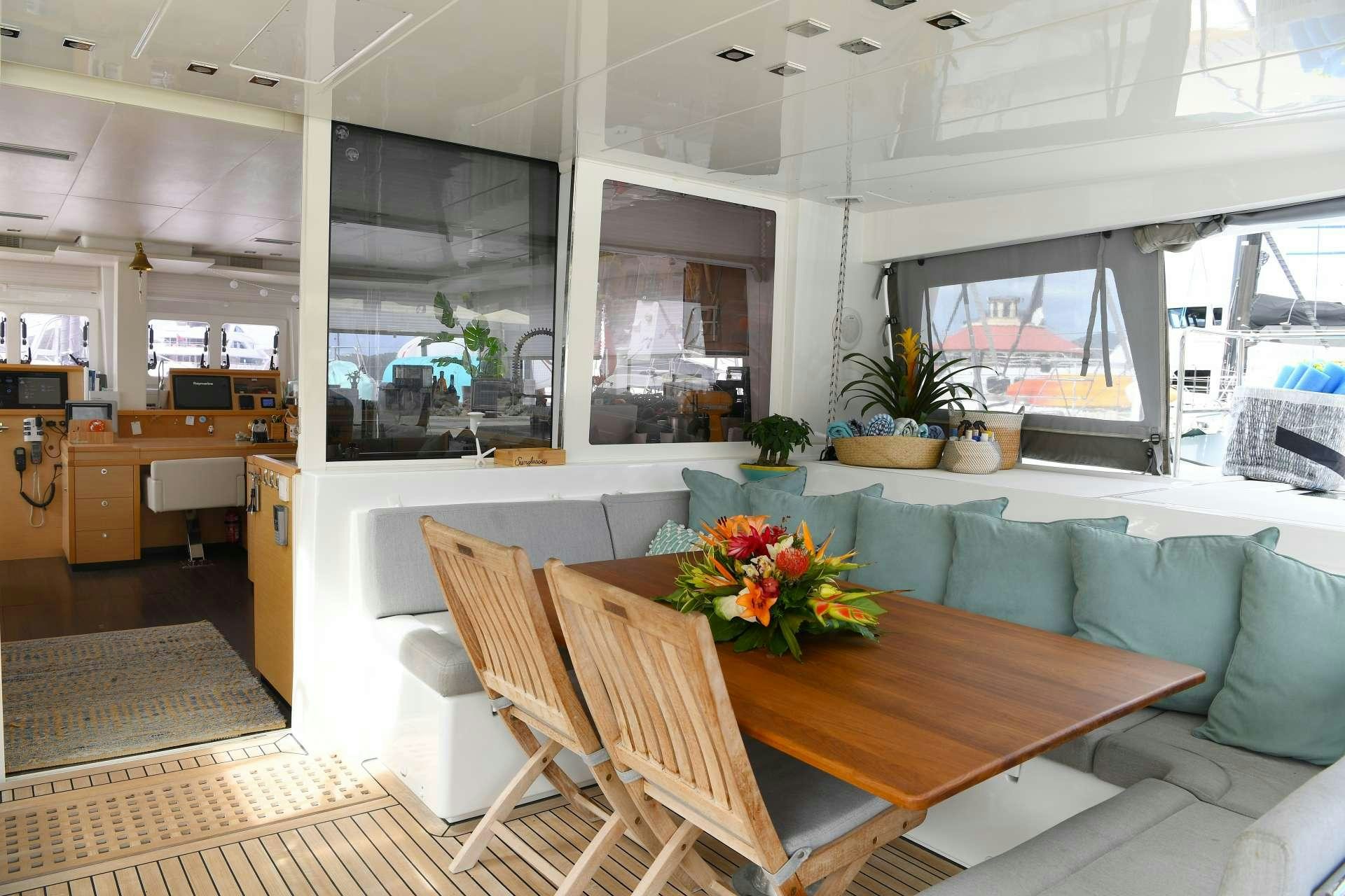 a room with a table and chairs aboard VIRAMAR Yacht for Charter