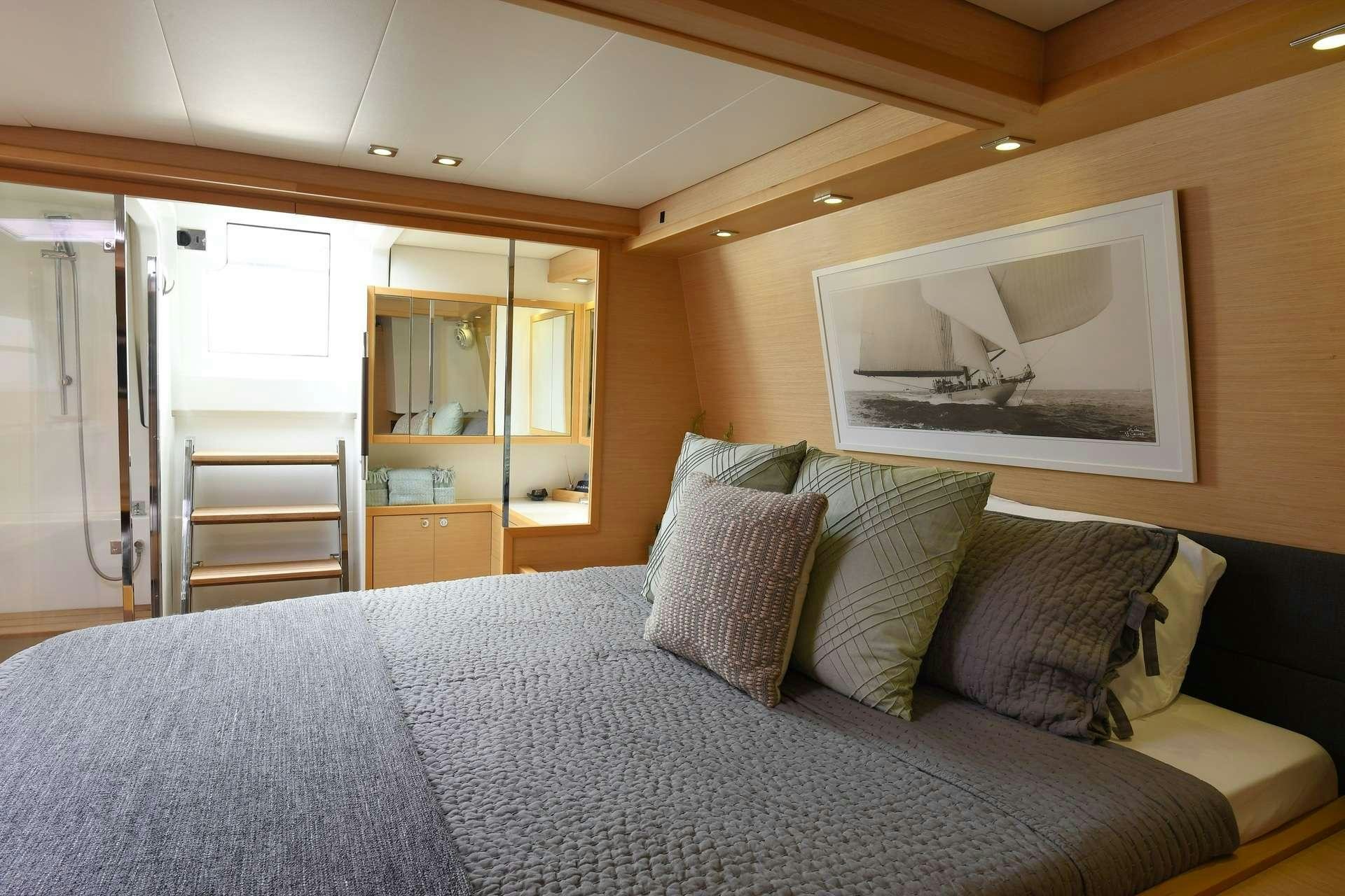 a bed with pillows aboard VIRAMAR Yacht for Charter