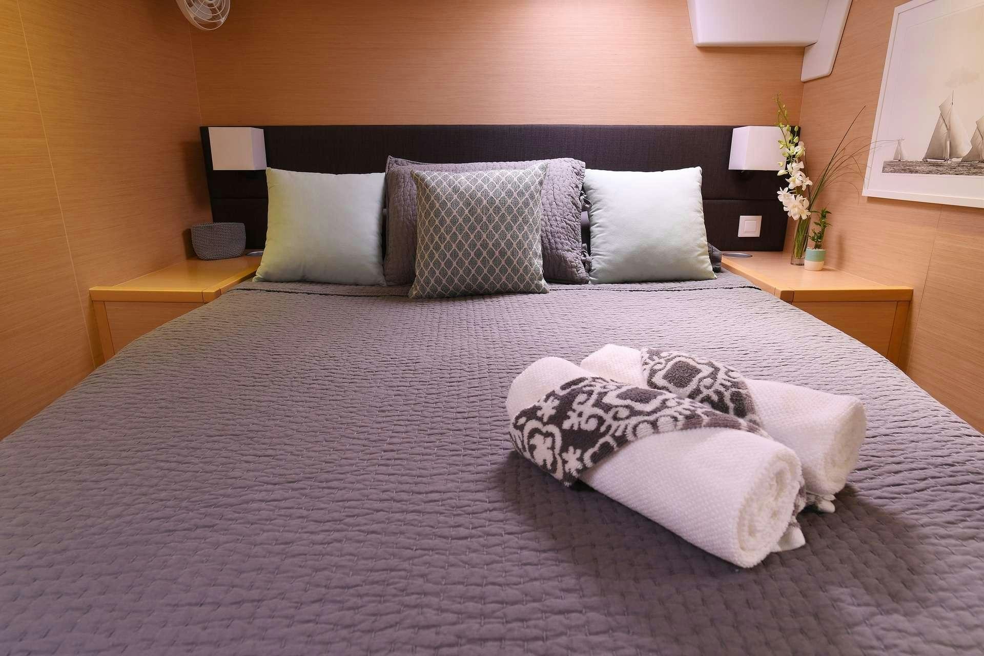 a bed with pillows aboard VIRAMAR Yacht for Charter