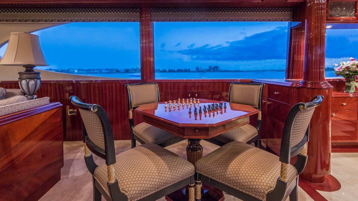a room with a table and chairs aboard CEDAR ISLAND Yacht for Charter