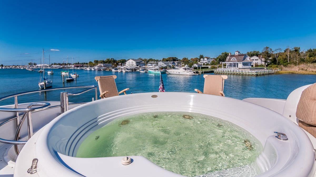 a pool with a chair and a chair on the edge of a body of water aboard CEDAR ISLAND Yacht for Charter