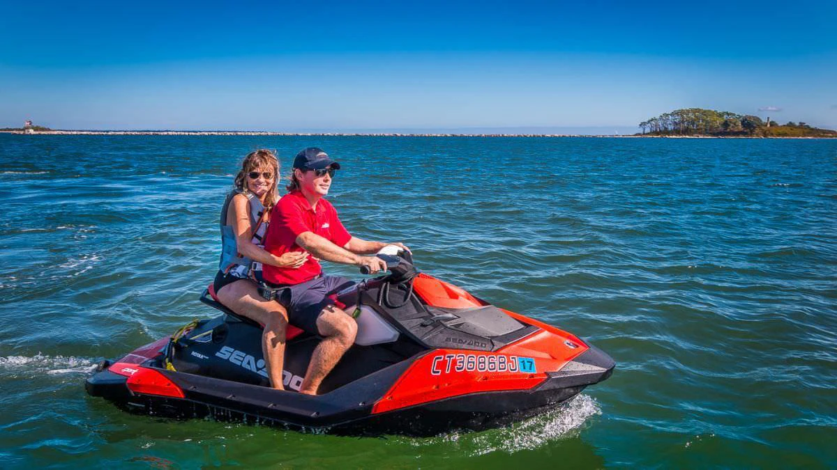 a man and woman riding a speedboat in the water aboard CEDAR ISLAND Yacht for Charter