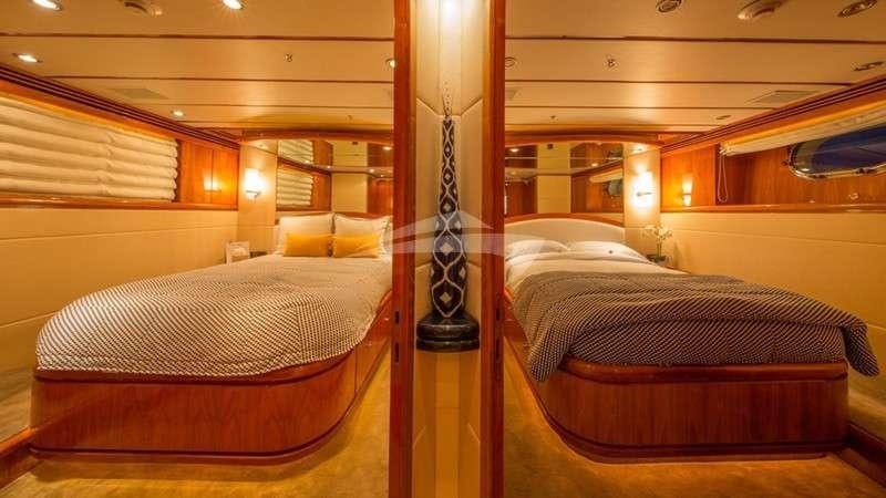 a couple of beds in a room aboard ANDIAMO Yacht for Charter