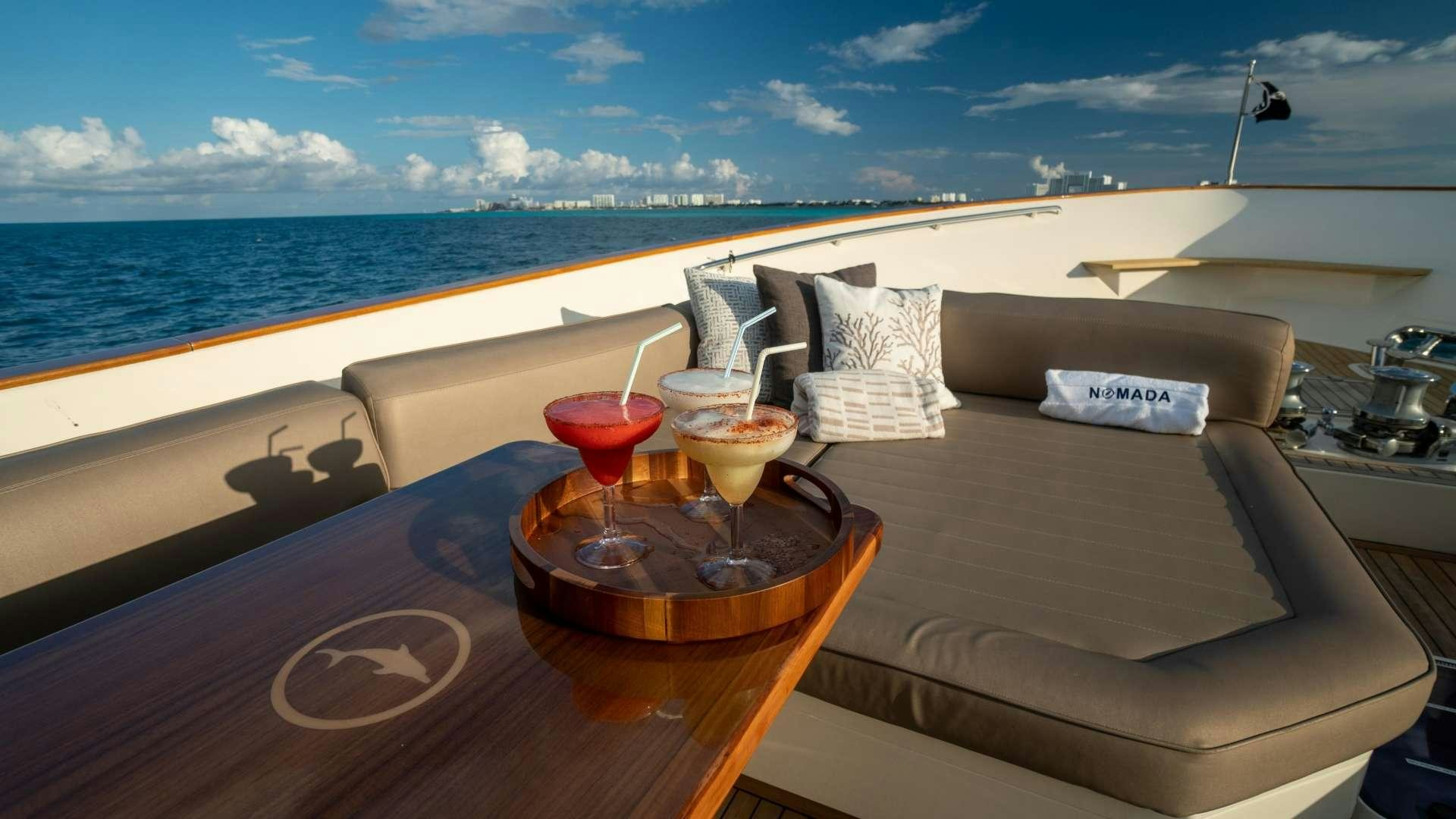 a table with drinks and pillows on it aboard NOMADA Yacht for Charter