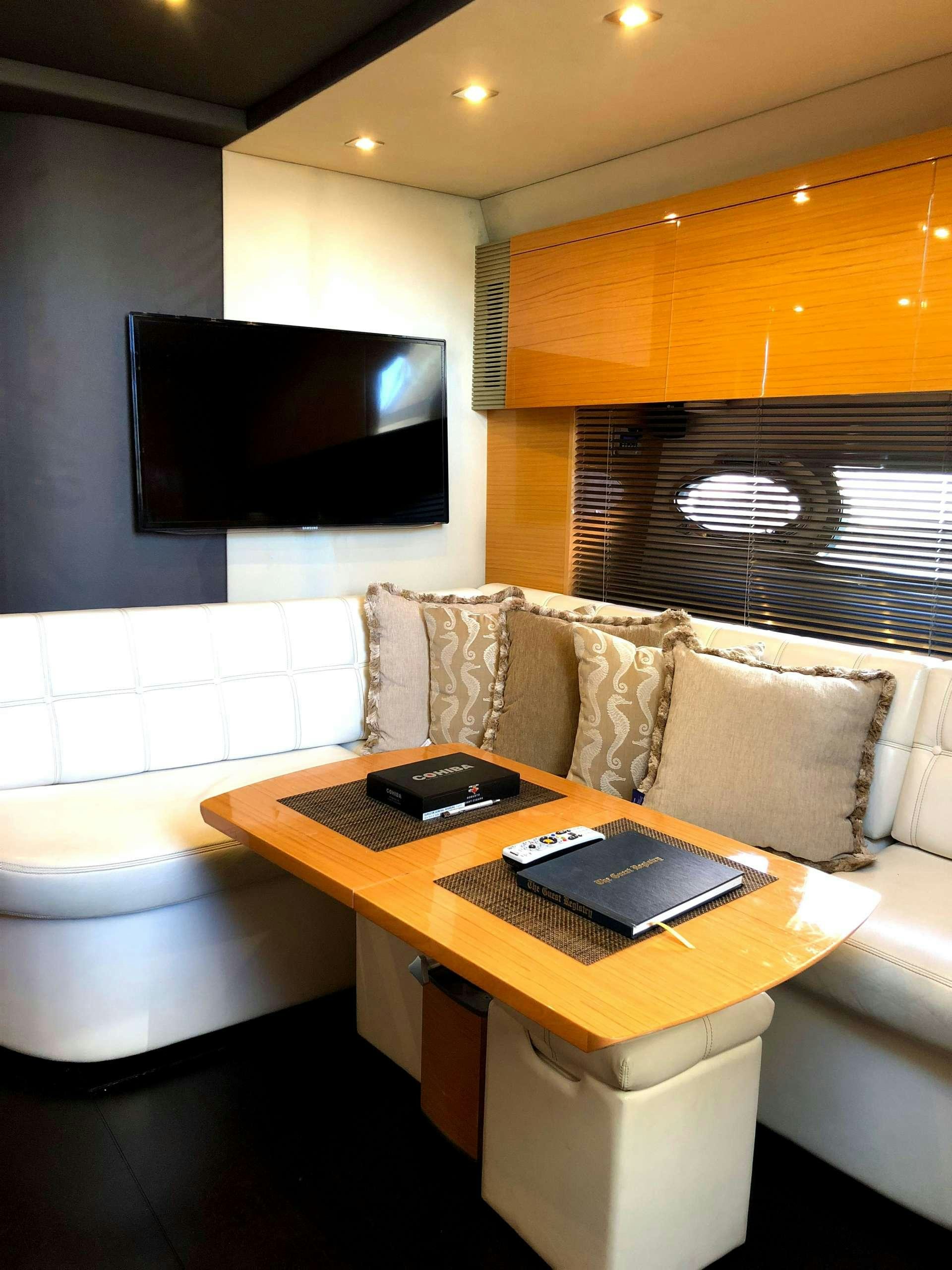 a living room with a tv and a couch aboard SOL Yacht for Charter
