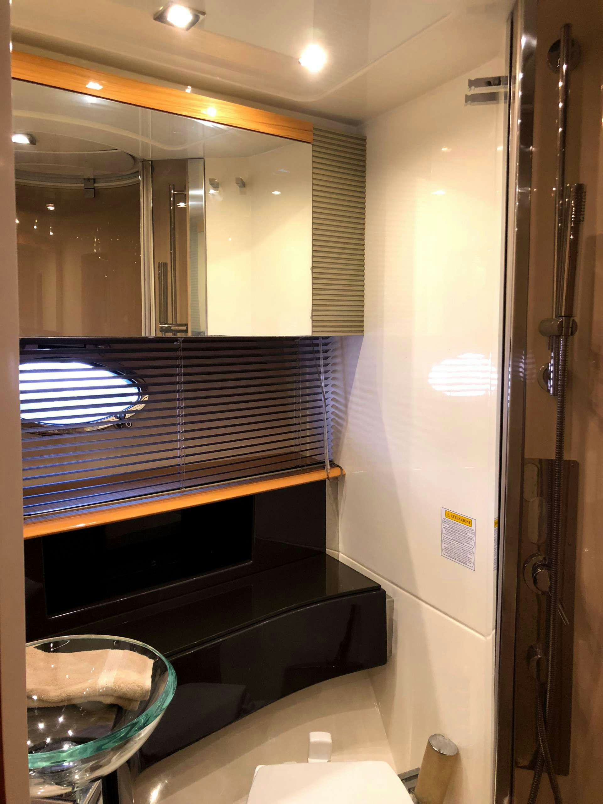 a bathroom with a large mirror aboard SOL Yacht for Charter
