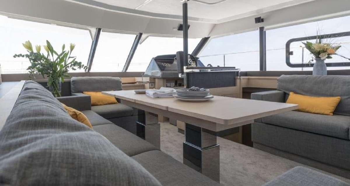 a room with a couch and a table aboard Hondo Yacht for Charter
