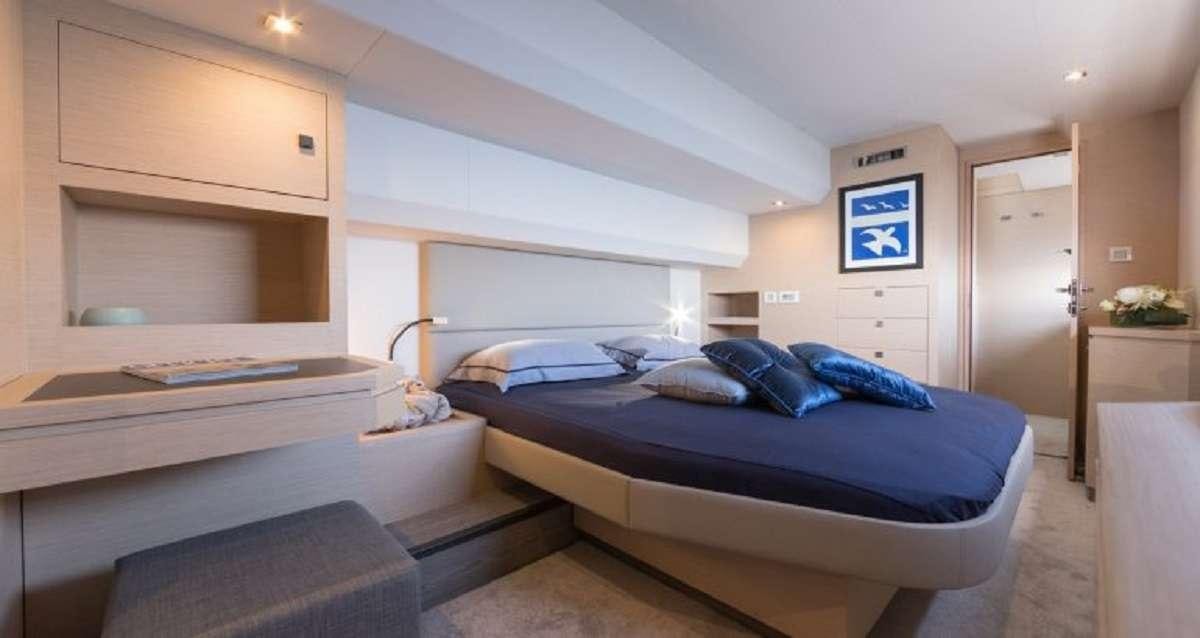 a room with a bed and a desk aboard Hondo Yacht for Charter