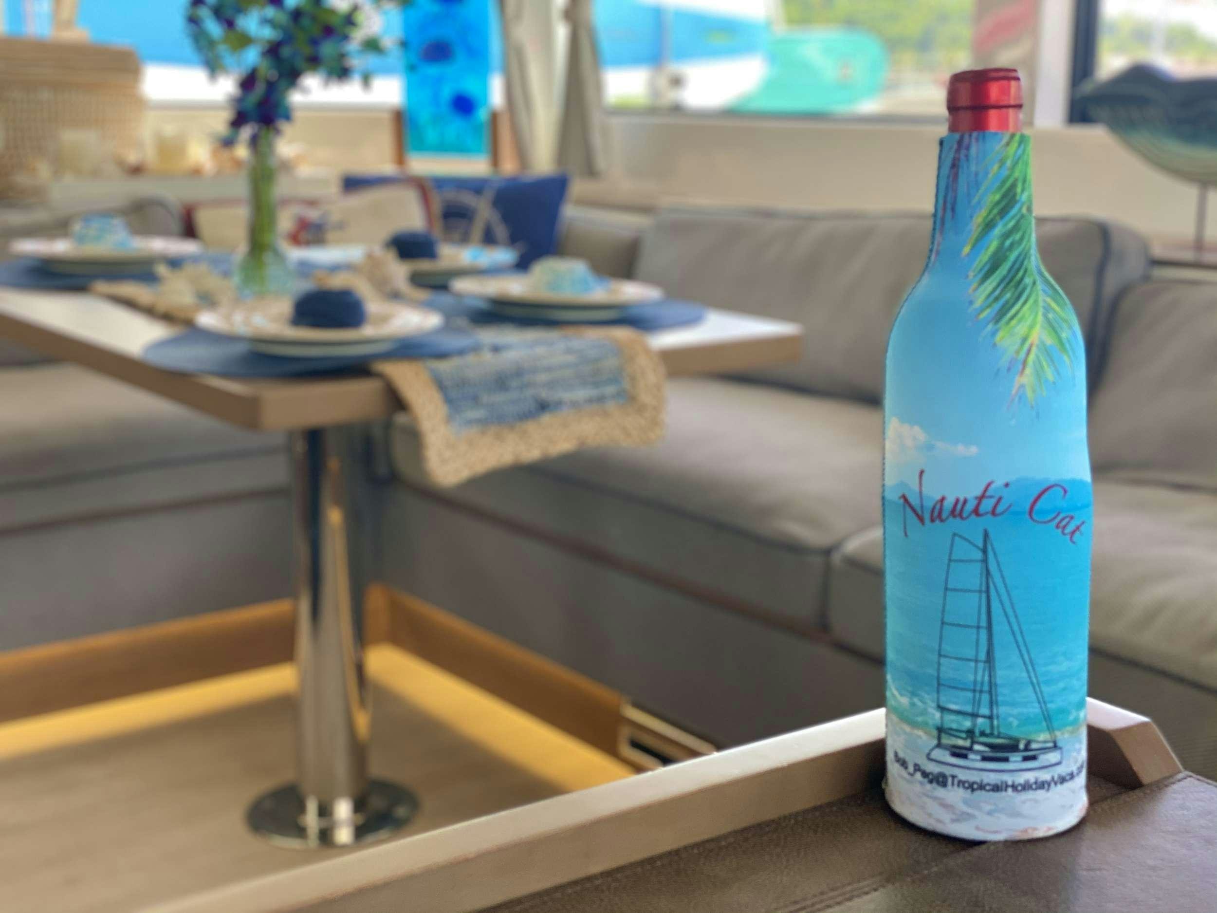 a bottle of water on a table aboard NAUTI CAT Yacht for Charter