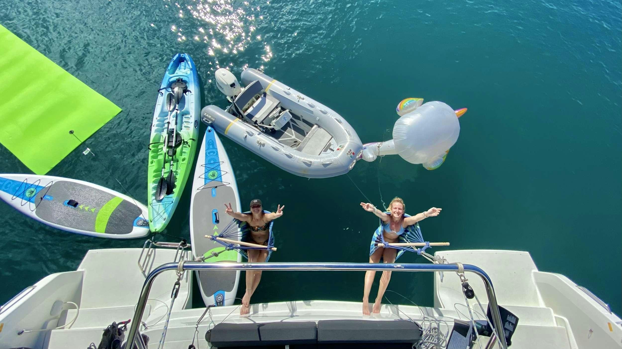 a couple of people on a boat aboard NAUTI CAT Yacht for Charter