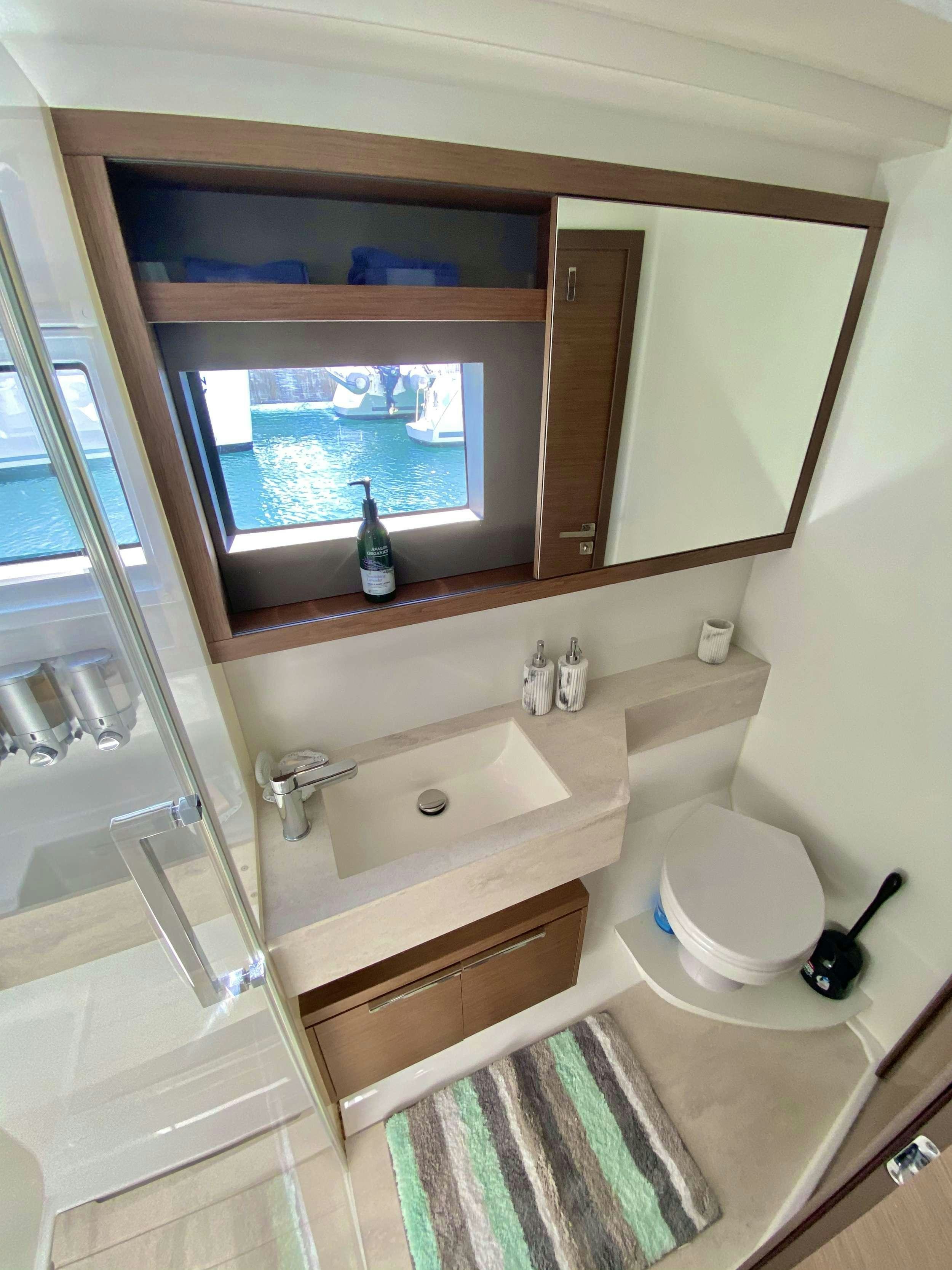 a bathroom with a sink and a toilet aboard NAUTI CAT Yacht for Charter
