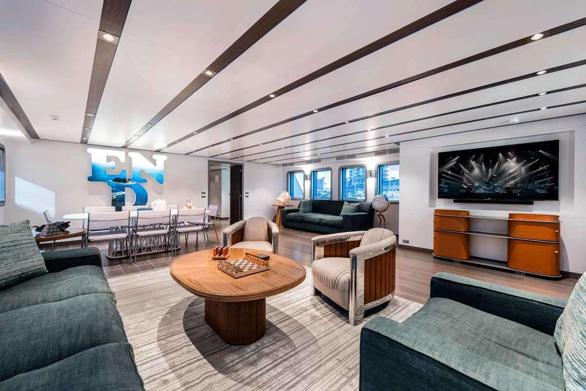 a living room with a large screen aboard GENESIA Yacht for Charter