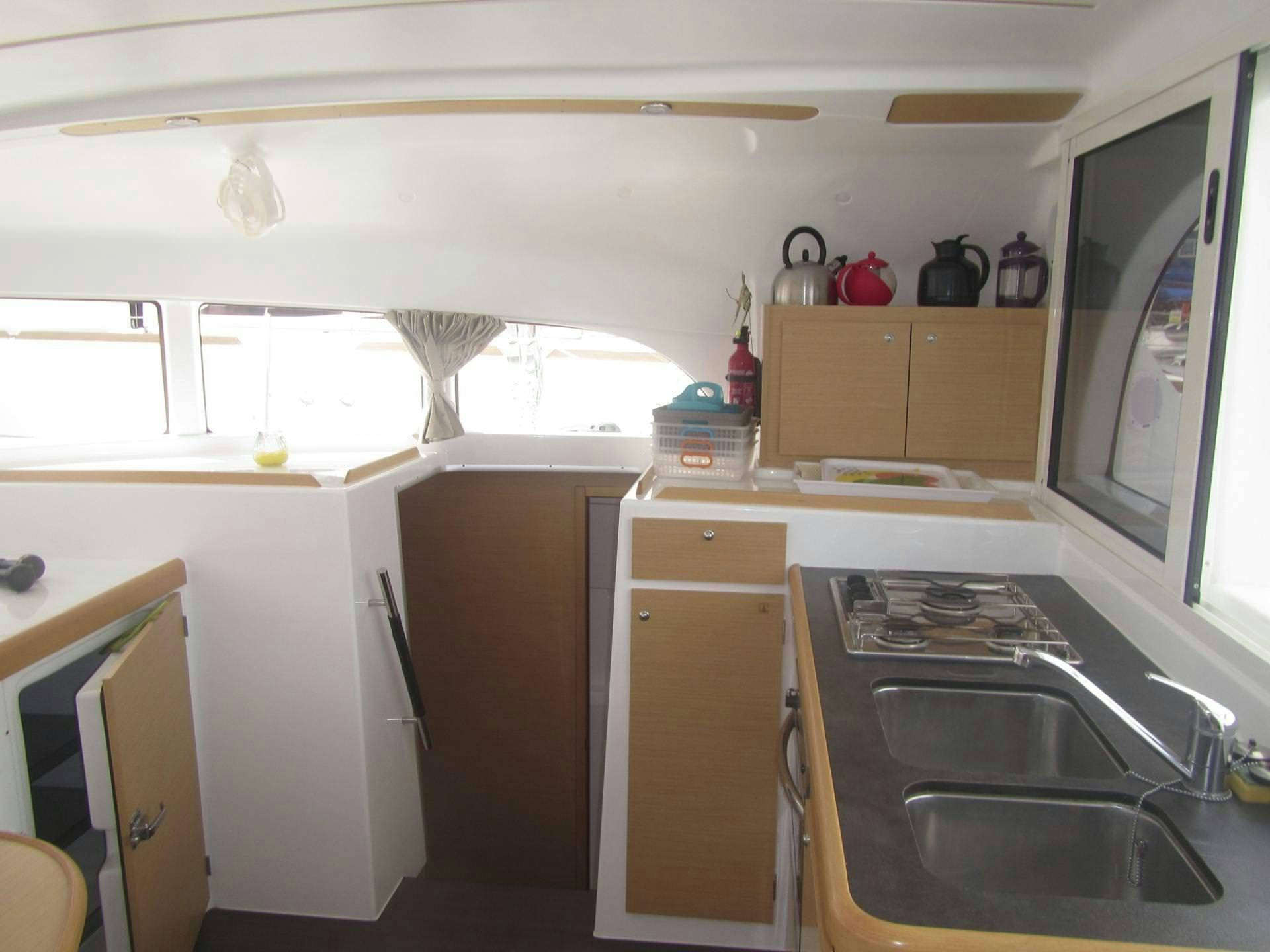 a kitchen with a sink and cabinets aboard HARMONY Yacht for Charter