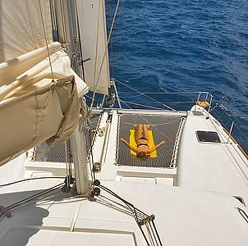 a boat with a yellow object on the front aboard HARMONY Yacht for Charter