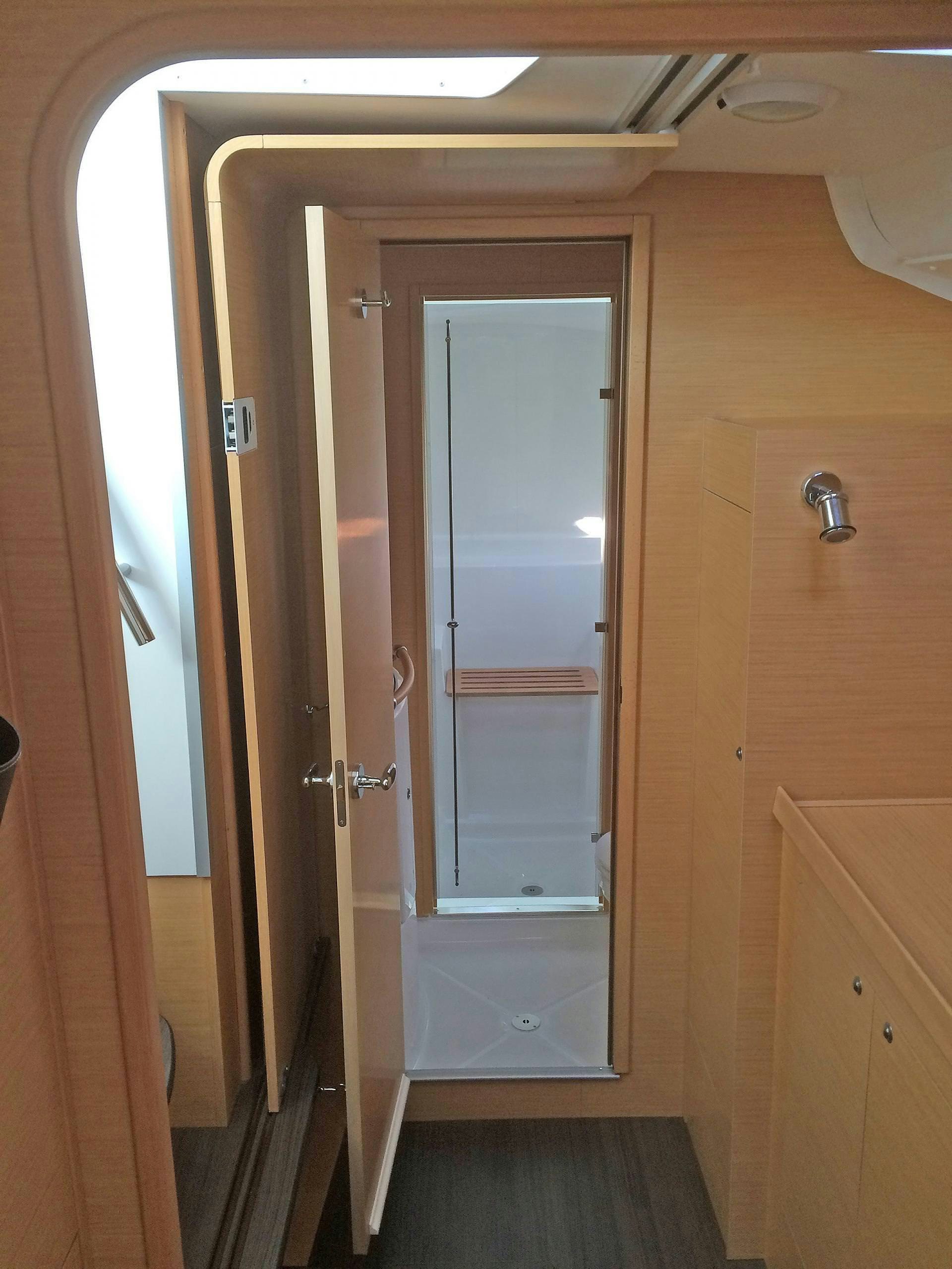 a room with a door and a mirror aboard HARMONY Yacht for Charter