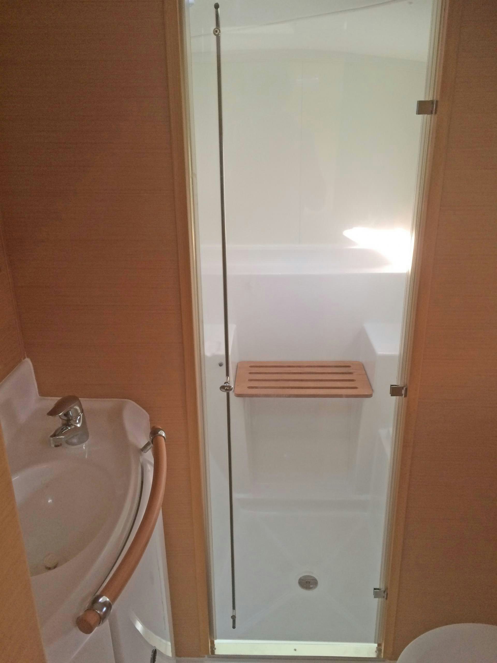 a bathroom with a shower and sink aboard HARMONY Yacht for Charter