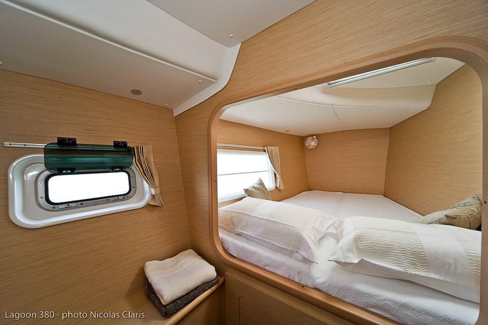 a bed with a television on the wall aboard HARMONY Yacht for Charter