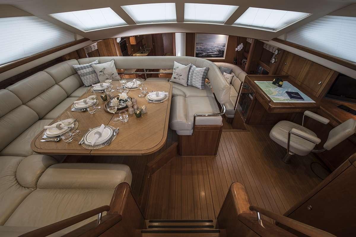 a room with a table and chairs aboard MIDNIGHT Yacht for Charter
