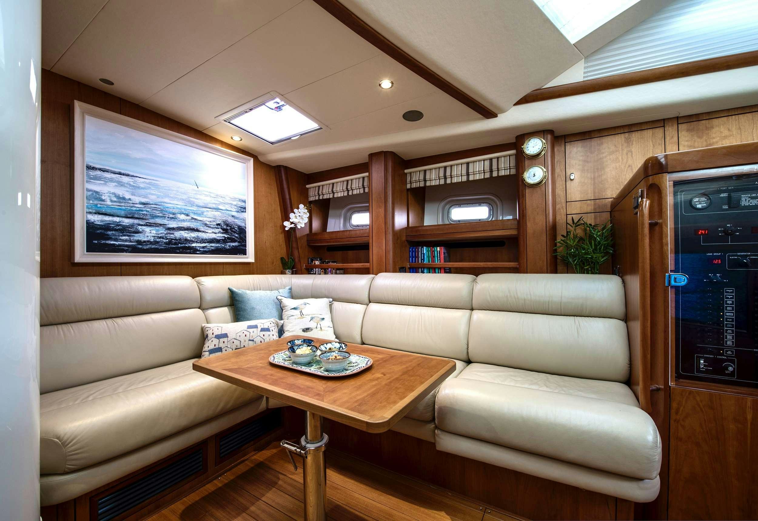 a living room with a couch and a coffee table aboard MIDNIGHT Yacht for Charter