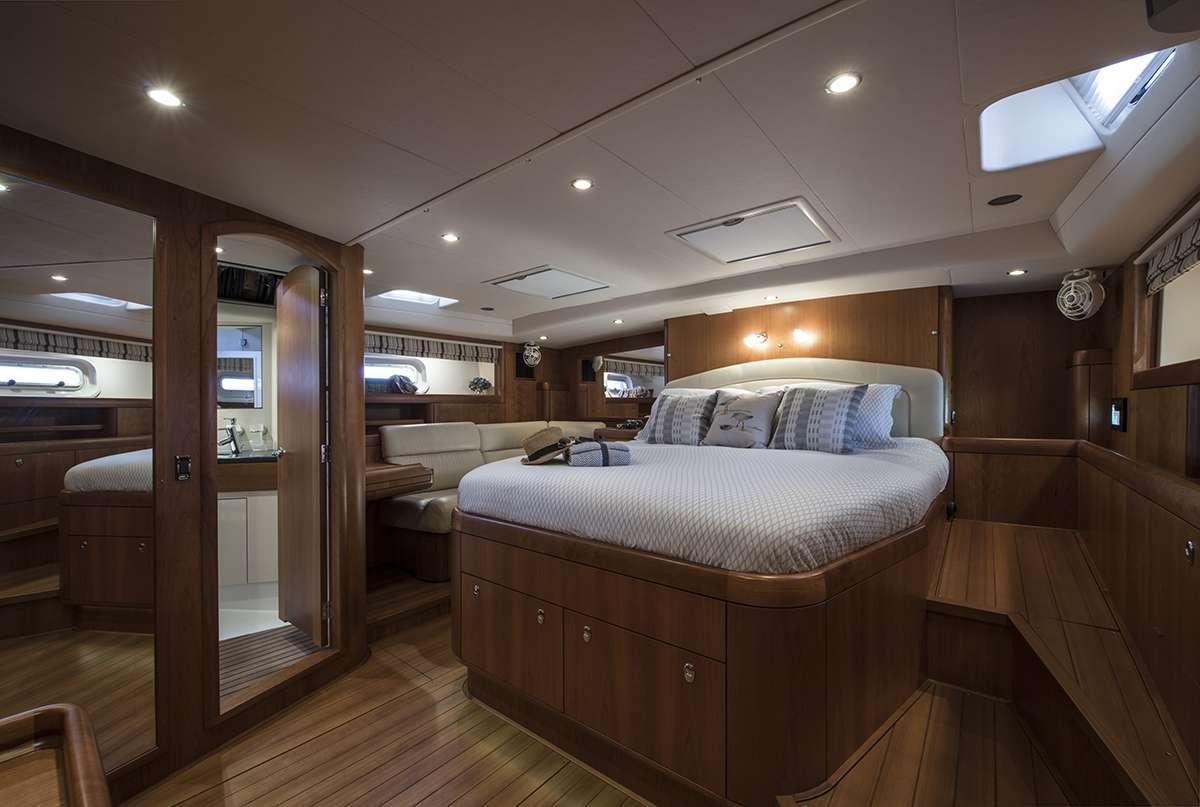 a bedroom with a bed and a couch aboard MIDNIGHT Yacht for Charter