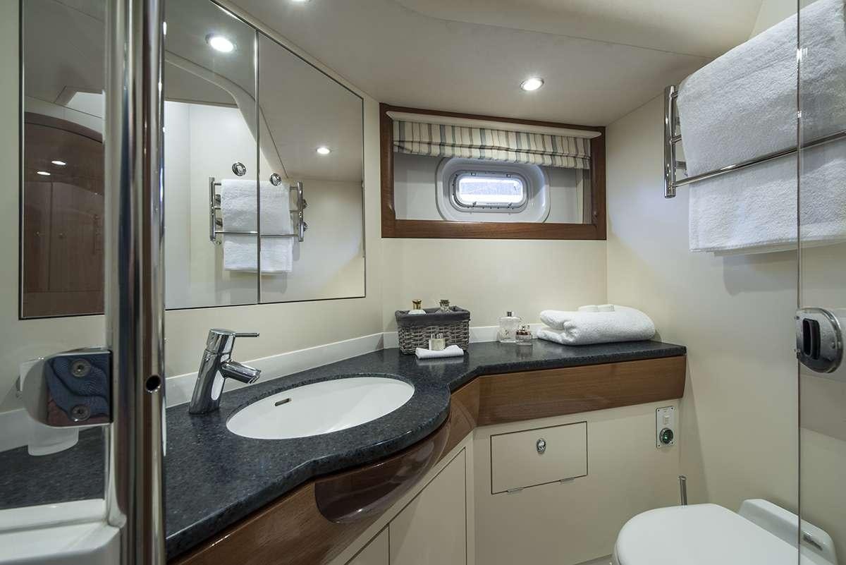 a bathroom with a sink and mirror aboard MIDNIGHT Yacht for Charter