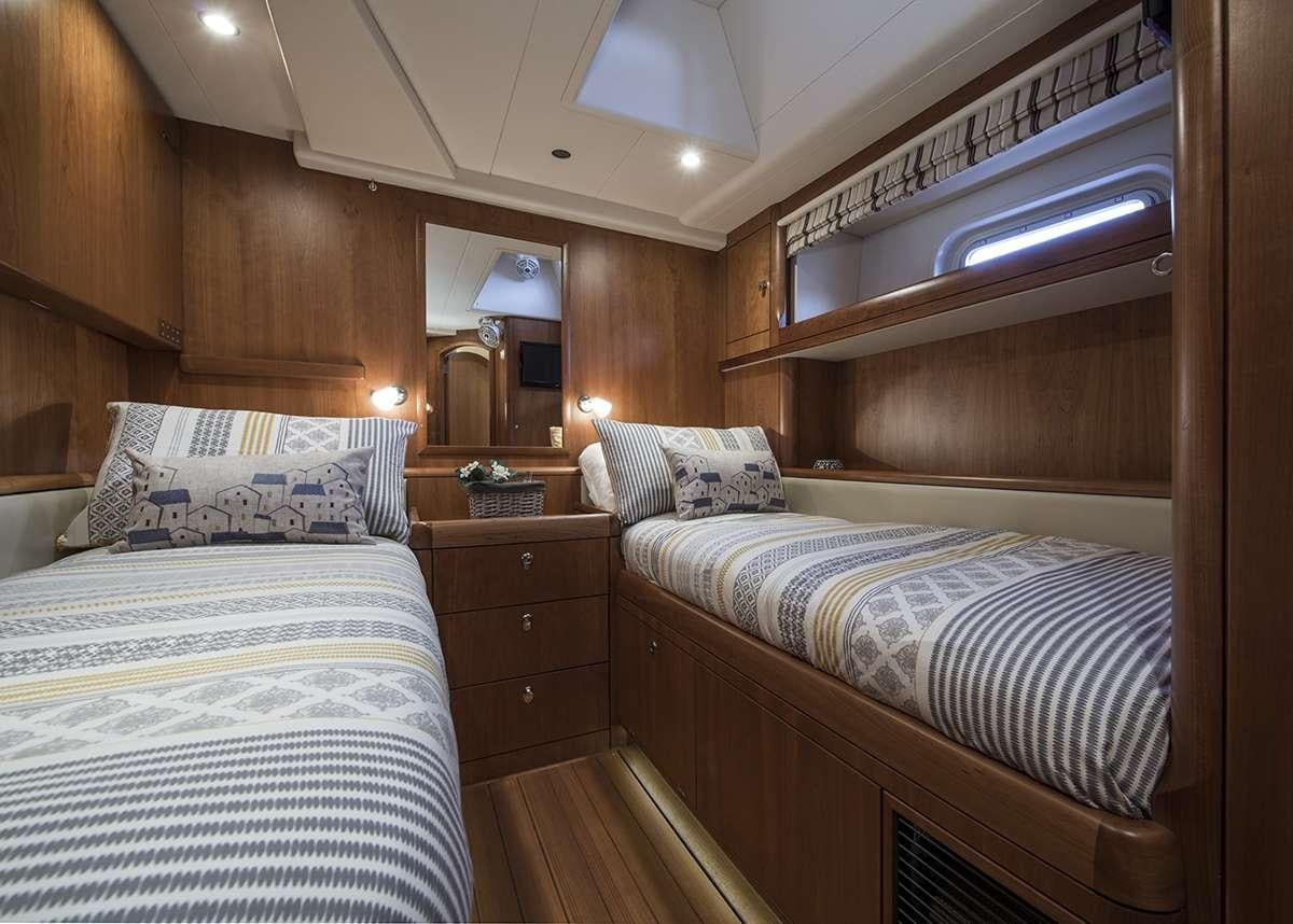 a couple of beds in a cabin aboard MIDNIGHT Yacht for Charter